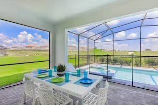 Covered patio dining area beside the pool